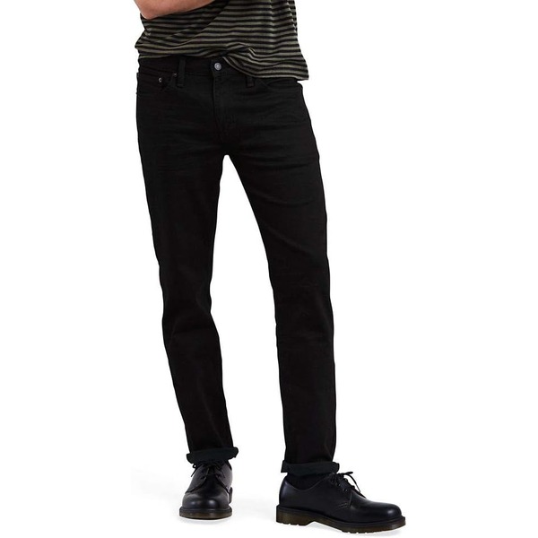 a man wearing slim fit jeans with lace up boots
