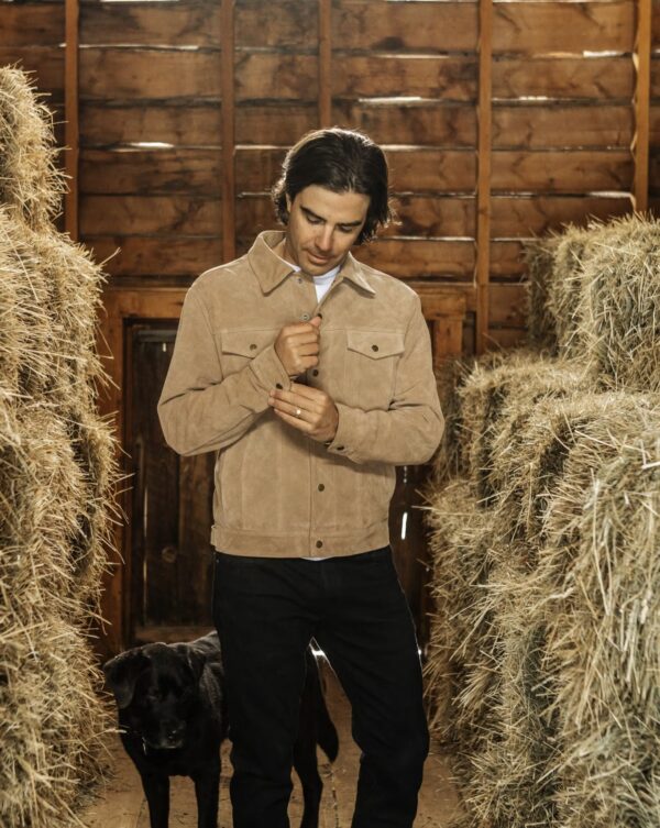 a man wearing a suede trucker jacket with slim pants