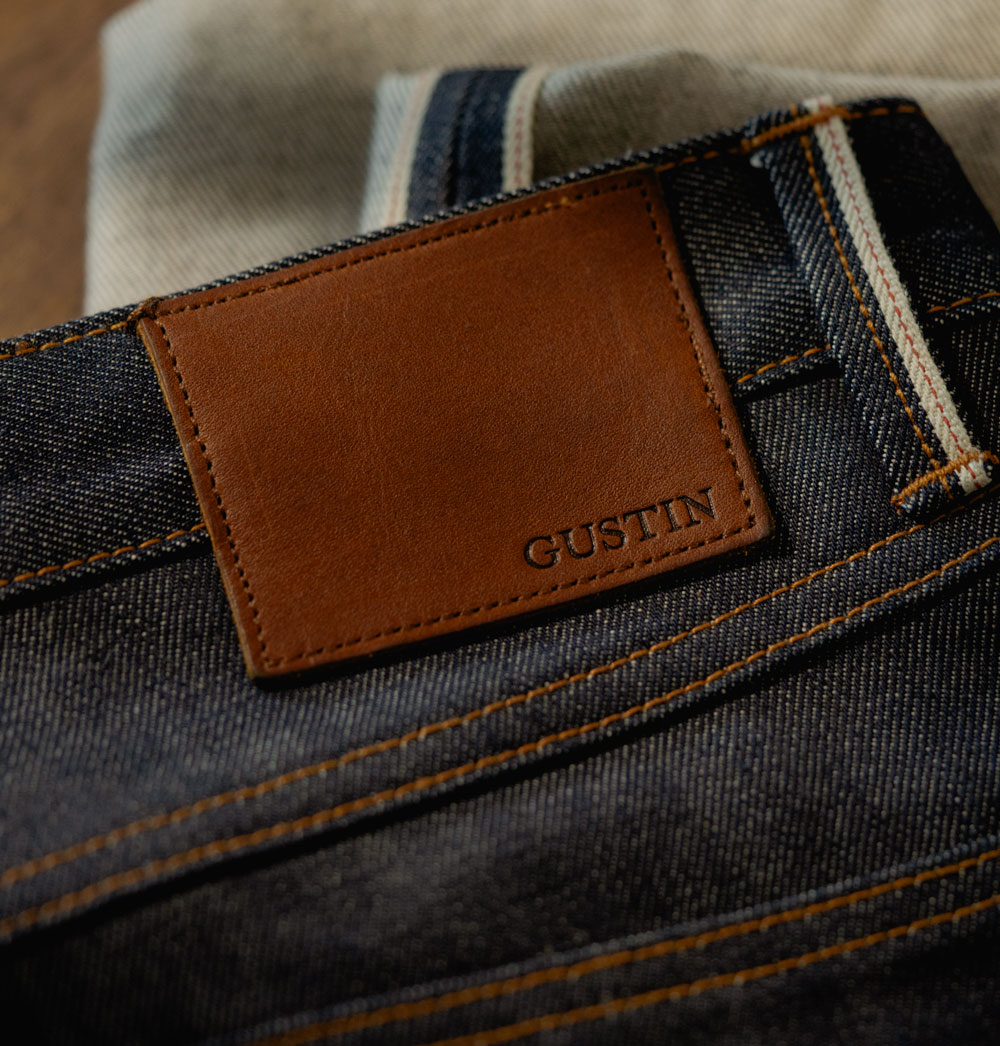 A close up of the leather Gustin patch on the back of the 1968 selvedge jeans