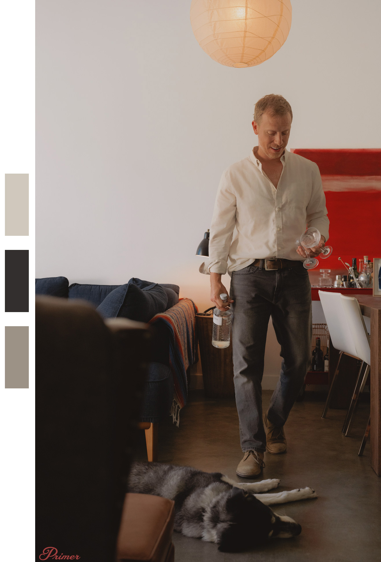 andrew in living room with hanging light and desk light
