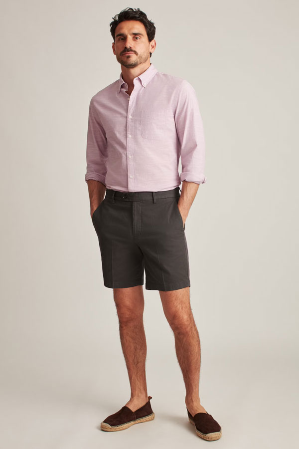 model wearing charcoal gray shorts that fit above the knee