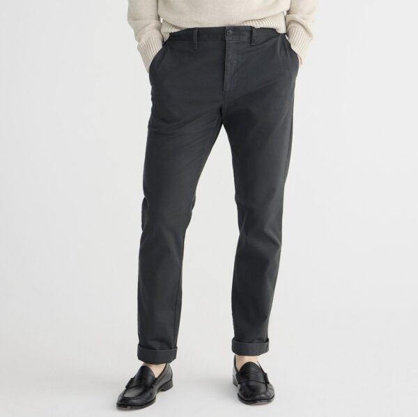 a man wearing straight fit chino pants with slip on loafer shoes