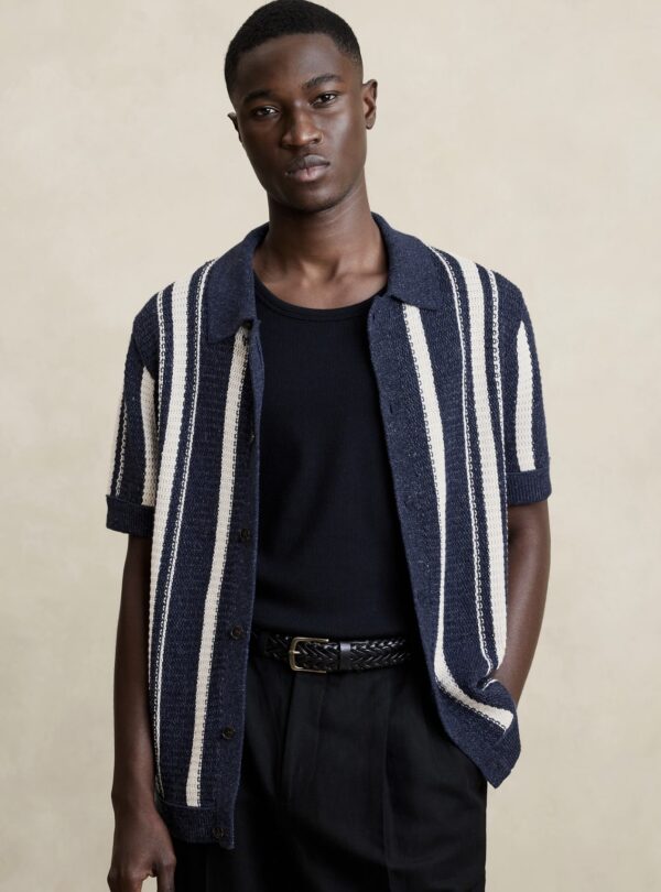 a man wearing a short sleeve cotton shirt unbuttoned over a crew neck shirt