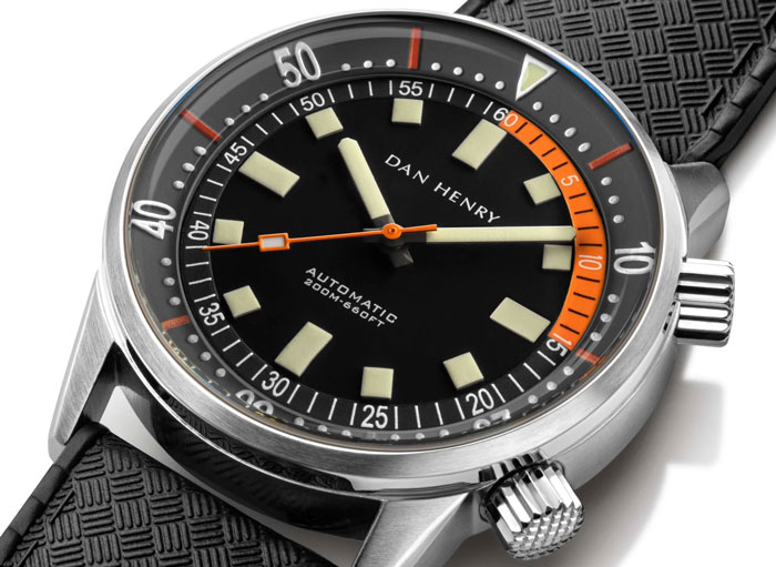 close up of a dan henry dive watch with an orange accent from the 12 to 3 positions