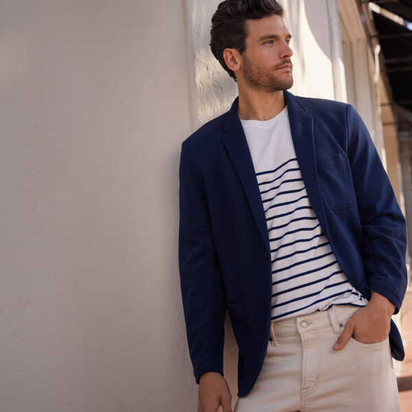 man wearing a terry blazer over a striped shirt and dress pants