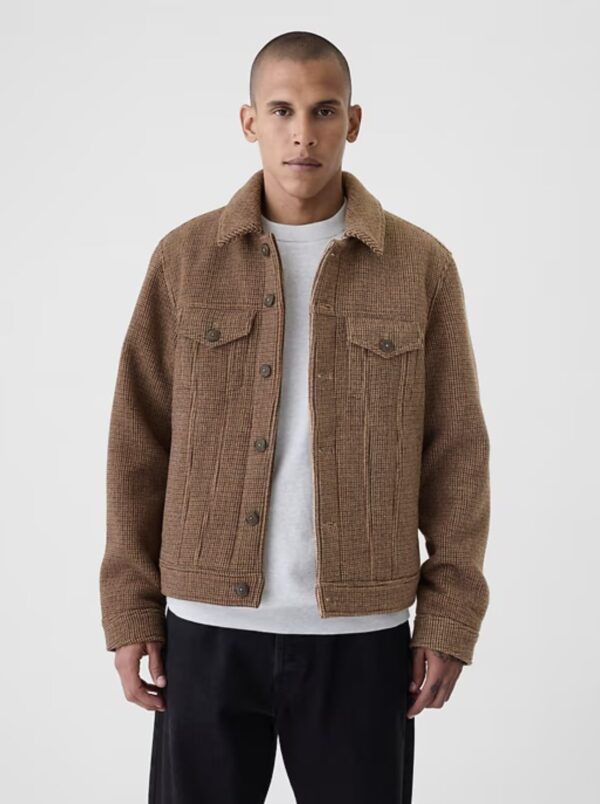 a man wearing a wool houndstooth pattern trucker style jacket over a shirt and pants