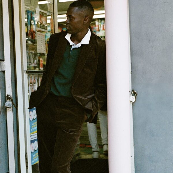 man wearing a corduroy suit jacket with a collared shirt and dress pants
