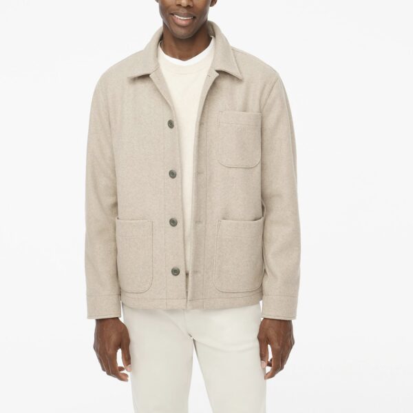 man wearing a knit chore style jacket over a crew neck shirt and pants