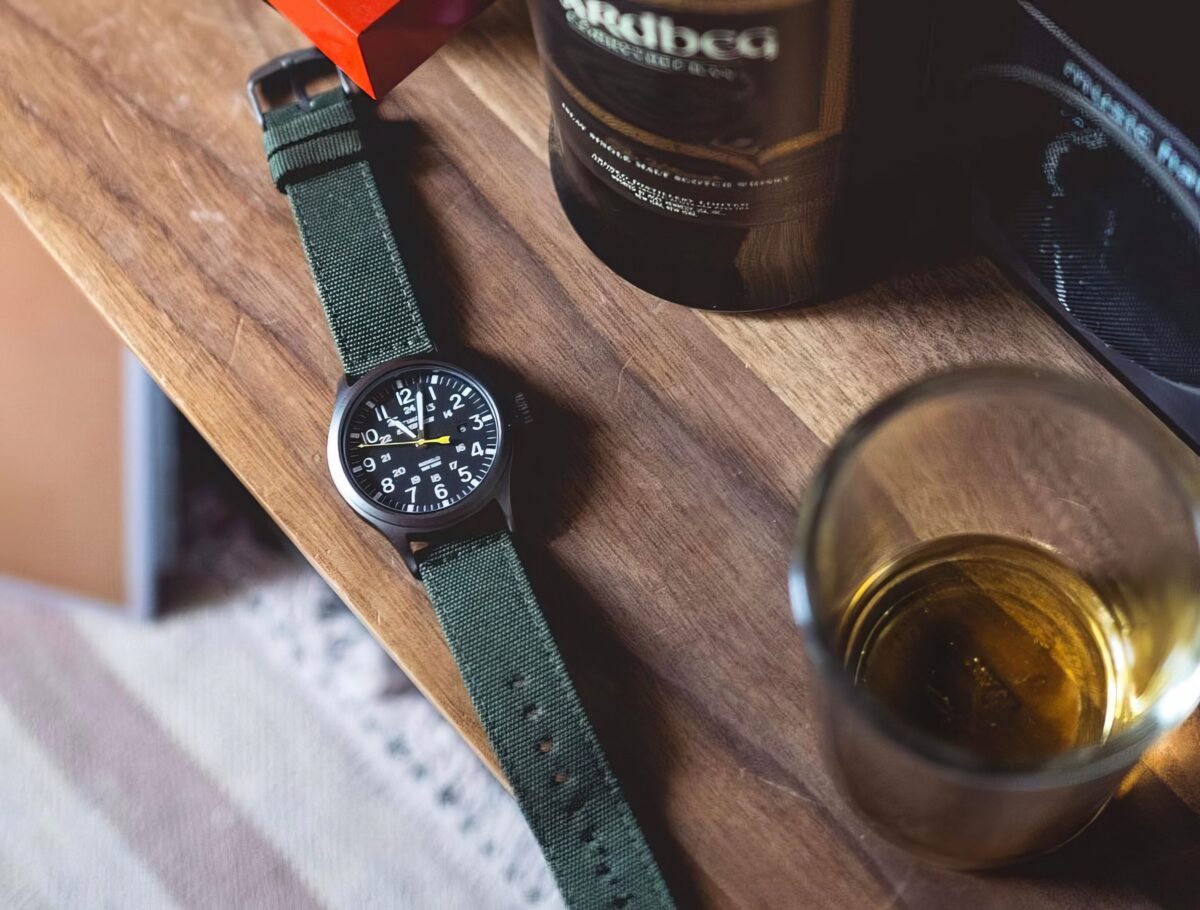 a modern field watch laying on a table
