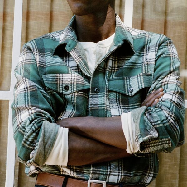 man wearing a plaid pattern long sleeve button front shirt