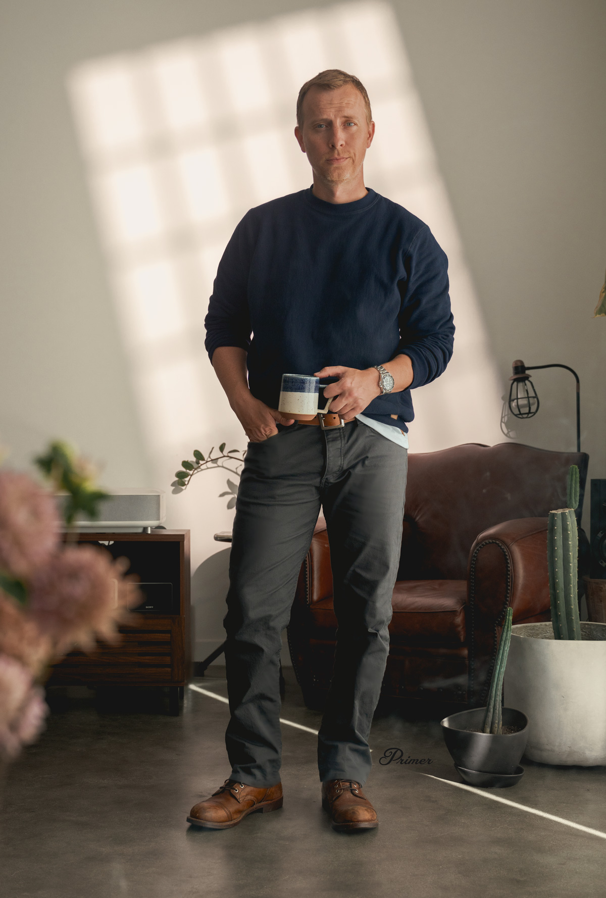 fall outfit with navy heavyweight sweatshirt, gray jeans, brown boots