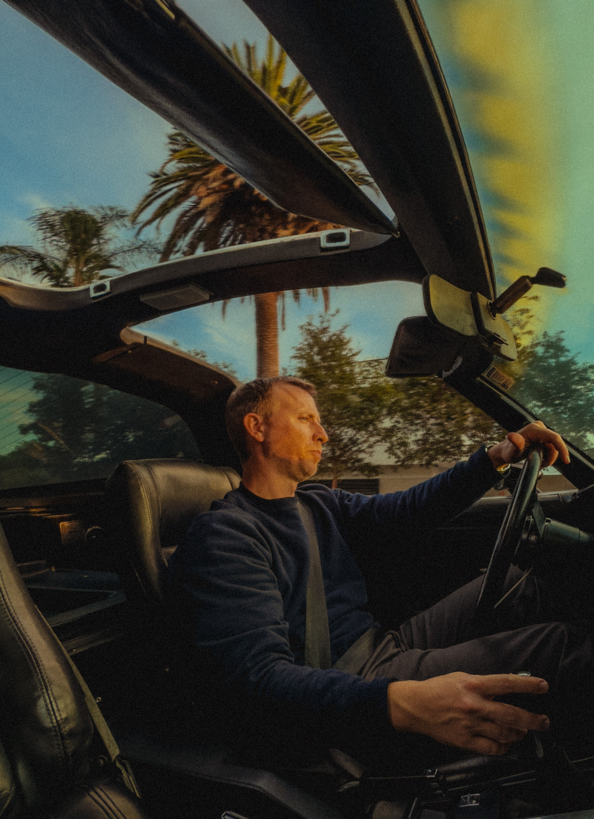 andrew driving in a car with the top down