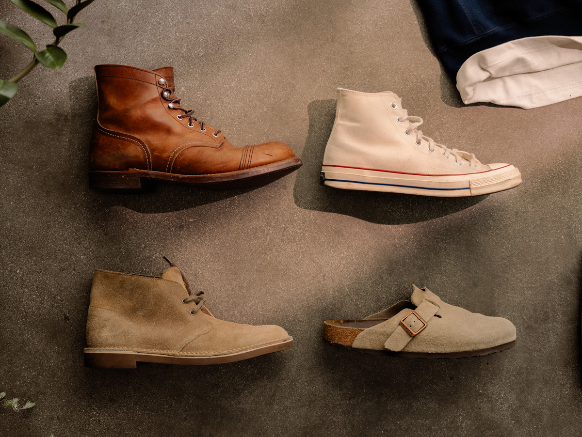 4 pairs of shoes, red wing iron rangers, converse high tops, desert boots, and birkenstock mules