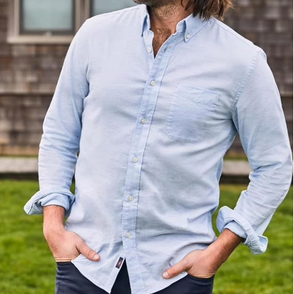a man wearing a long sleeve button front oxford shirt