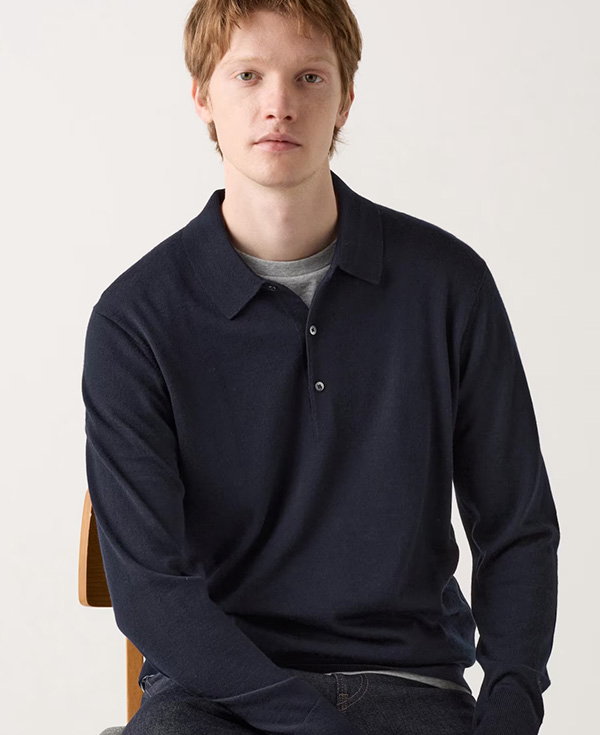 a man wearing an extra fine merino wool sweater polo shirt with long sleeve
