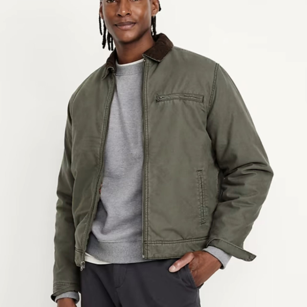 a man wearing a barn coat over a crew neck shirt