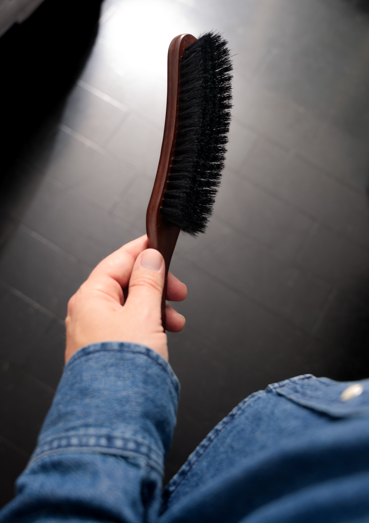 andrew holding a clothing brush