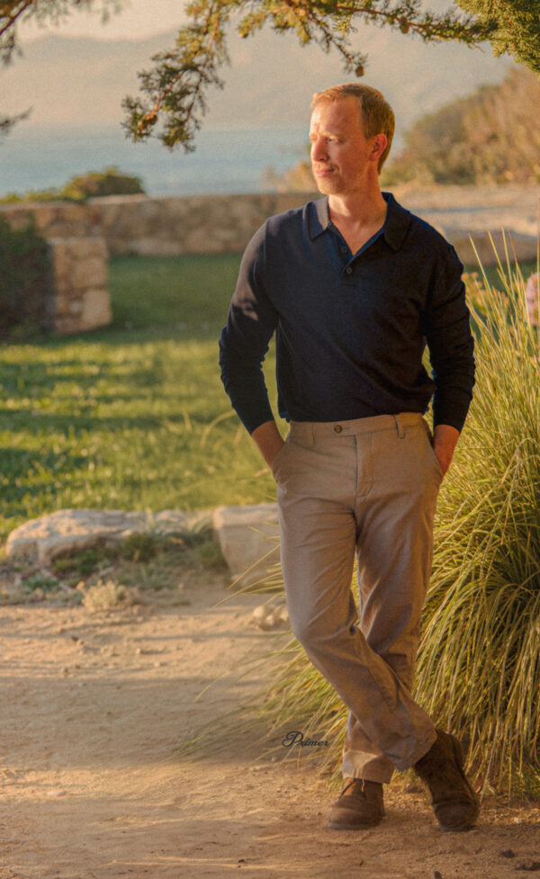 a man wearing a long sleeve collared shirt with dress pants