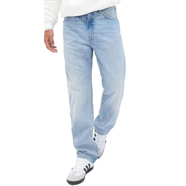 a man wearing original fit denim jeans with casual shoes