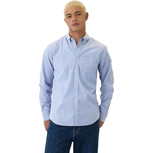 a man wearing a long sleeve poplin style button up shirt