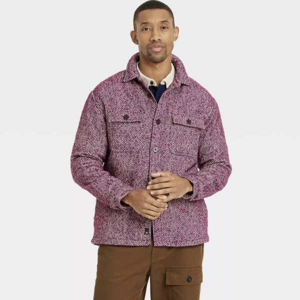 a man wearing a herringbone print shirt jacket over cord pants