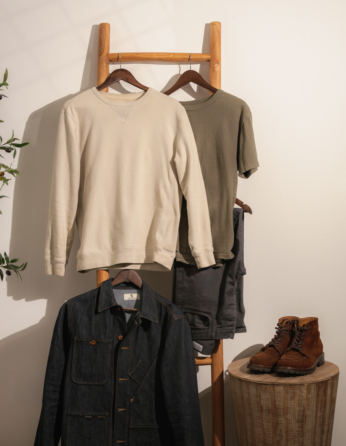 items of clothing hanging from a wooden ladder
