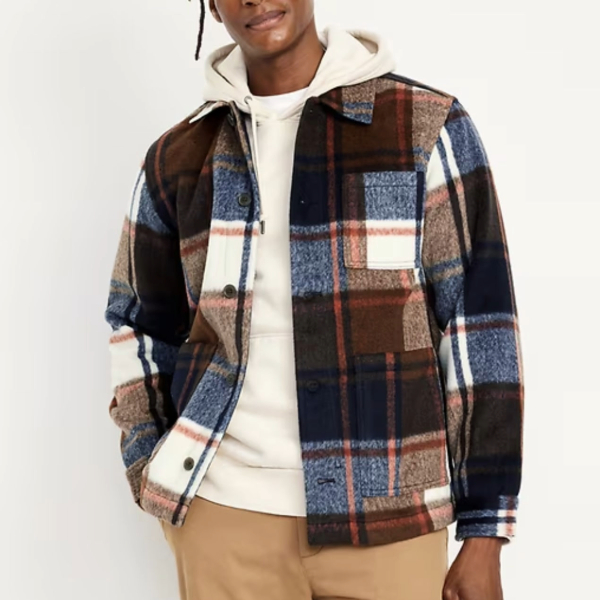 a man wearing a plaid pattern chore jacket over a shirt and pants