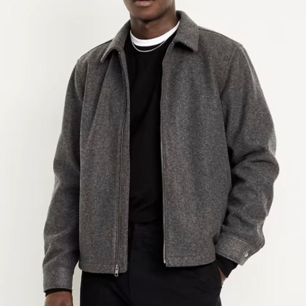 a man wearing a relaxed zip front jacket over a crew neck shirt