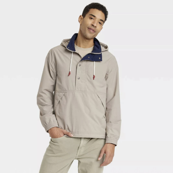 man wearing a ripstop material rain coat over a shirt and pants