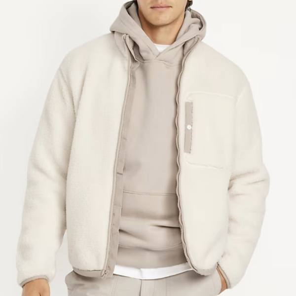 a man wearing a zip front sherpa jacket over a hoodie