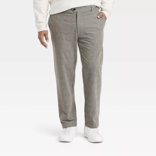 a man wearing suit pants with a sweater and casual shoes