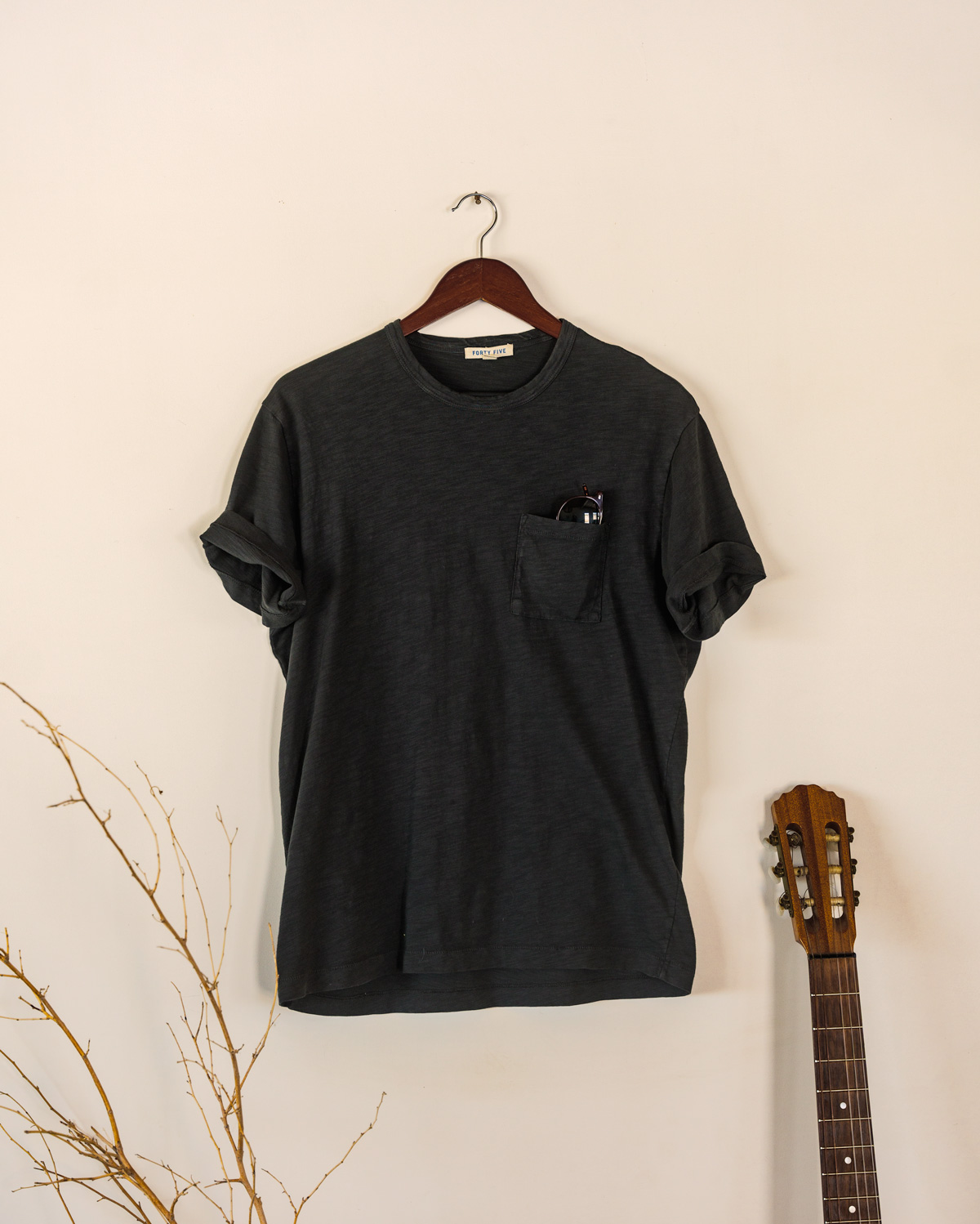faded black tshirt hanging on hanger