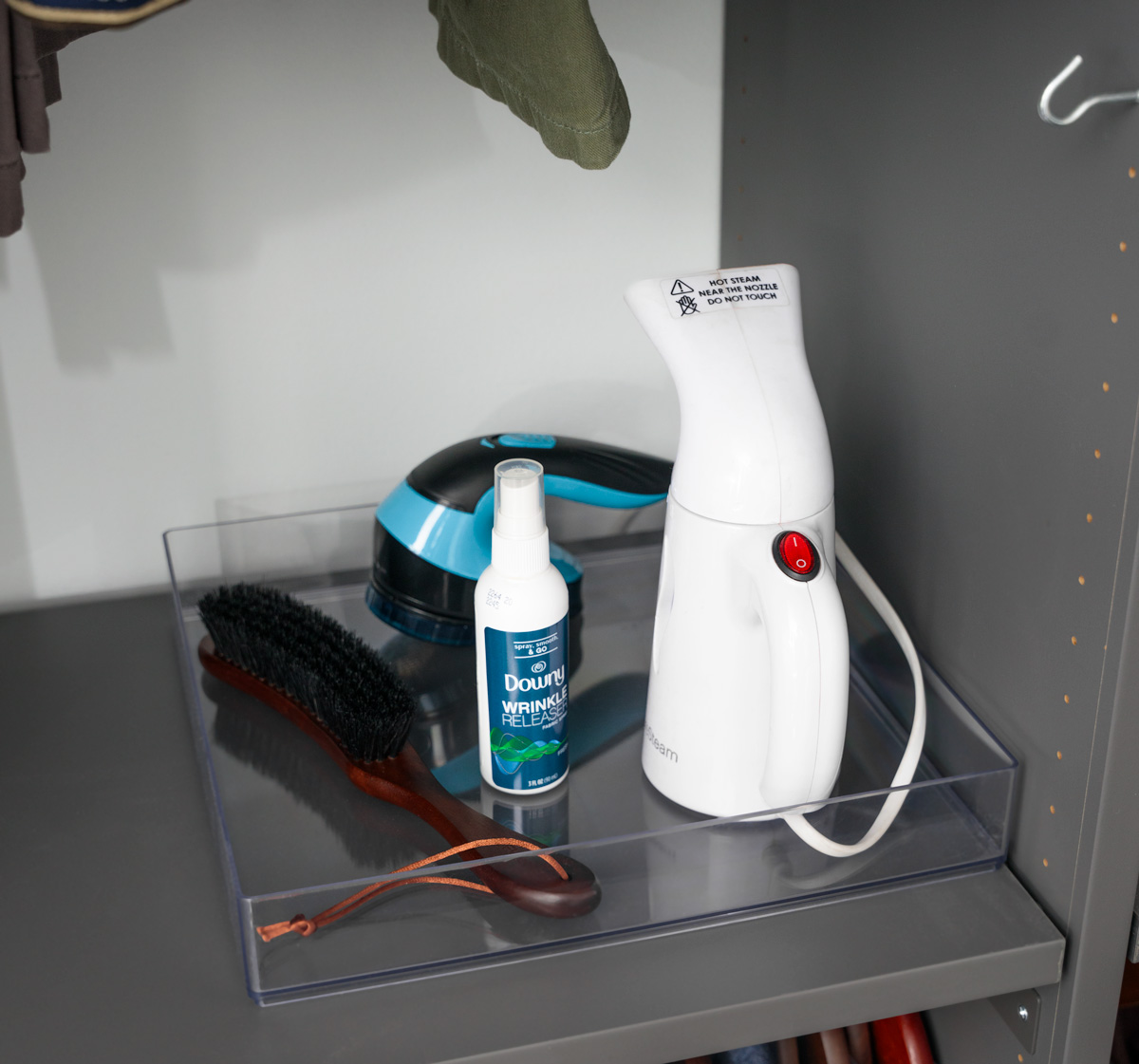 closet workstation with steamer, wrinkler releaser, brush, and shaver