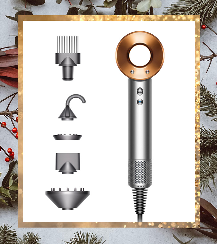 a dyson brand super sonic hair dryer with additional attachments and pieces