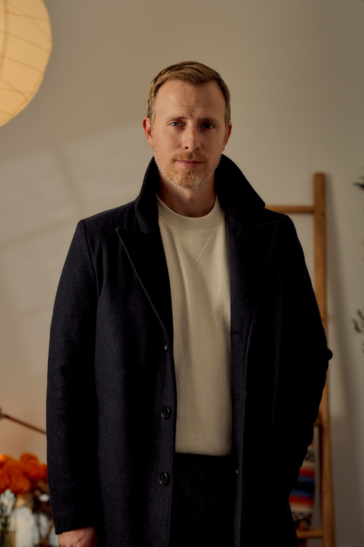 men's gray topcoat over beige sweater