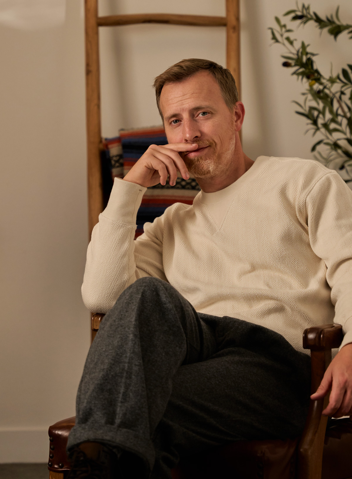 men's holiday outfit with beige sweater and gray pants