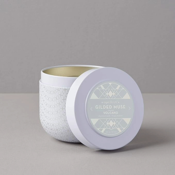 a scented candle in a tin holder