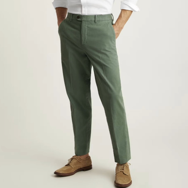 a man wearing chino pants with suede lace up boots