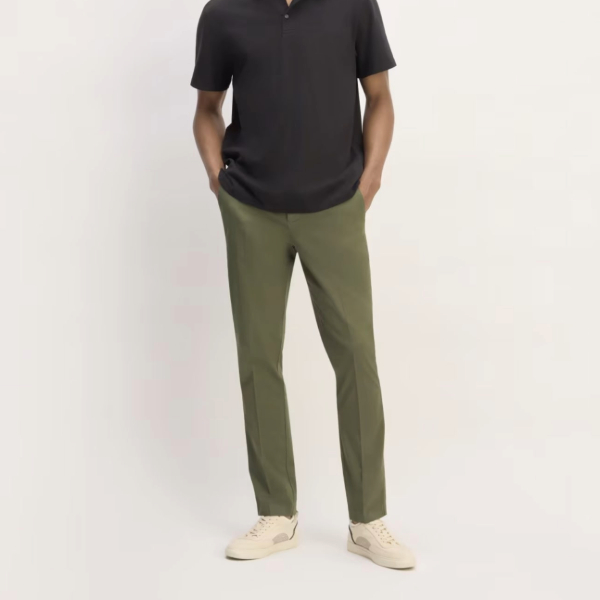 a man wearing tapered chino pants with casual shoes and a short sleeve shirt