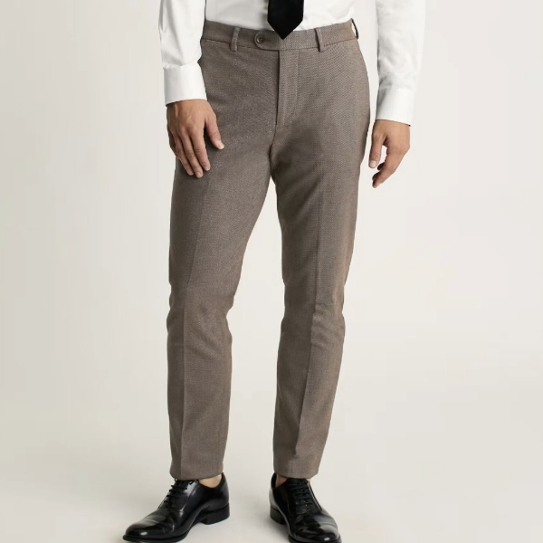a man wearing chino style pants with dress shoes