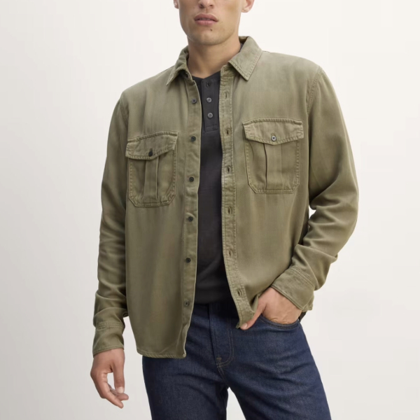 a man wearing a utility style overshirt with a crew neck shirt and pants