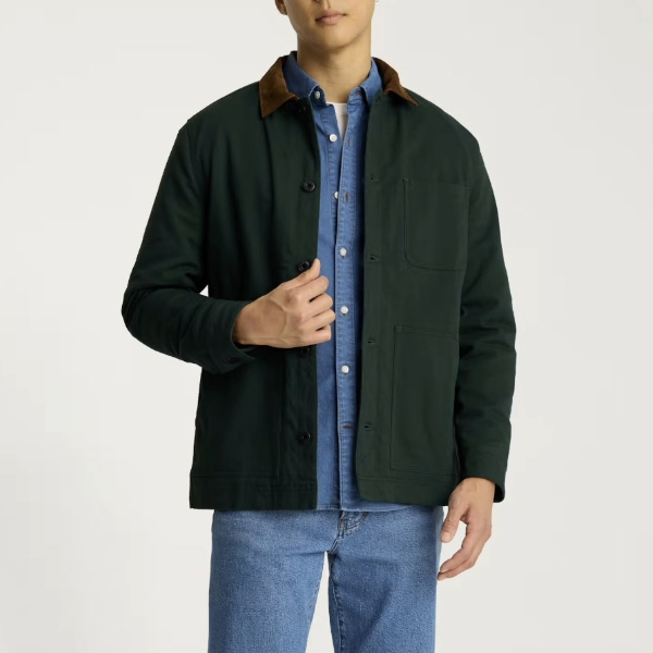 a man wearing fleece lined ranch style jacket over a button front shirt and jeans