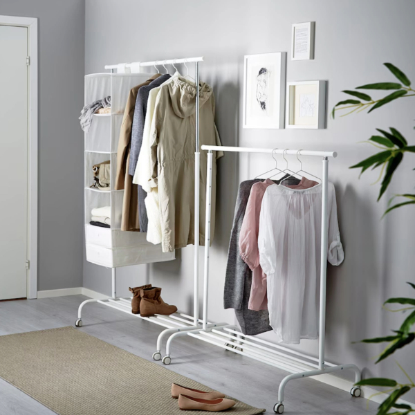 a clothes rack with several items of clothing on hangers and additional storage space
