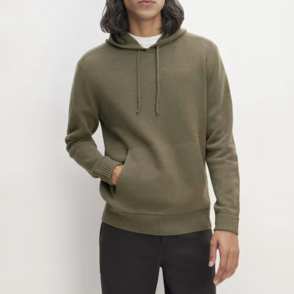 a man wearing a felted merino wool pullover hoodie and pants