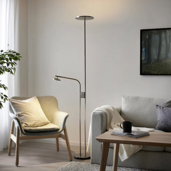 a nickel plated floor lamp in a living room space