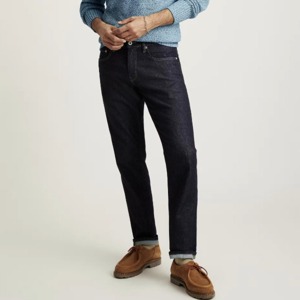 a man wearing lightweight stretch denim jeans and suede boots