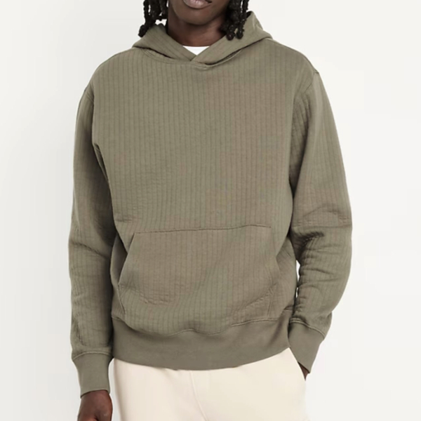 a man wearing a quilted fleece hoodie over casual pants