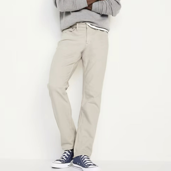 a man wearing five pocket pants with a sweater and casual shoes