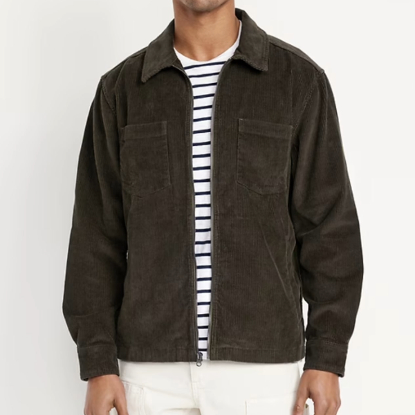 a man wearing a zip front corduroy shirt jacket over a striped shirt and casual pants