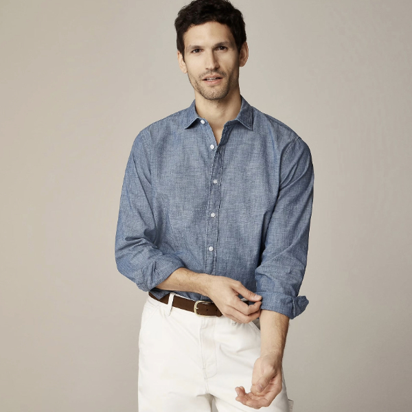 a man wearing a wrinkle free dress shirt over pants